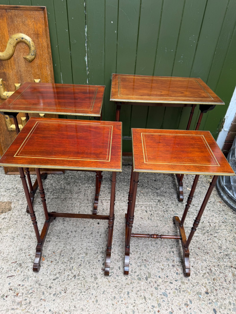 An early nineteenth-century Regency quartetto set of four rosewood nesting tables with brass line inlay and slender turned legs. View IX
