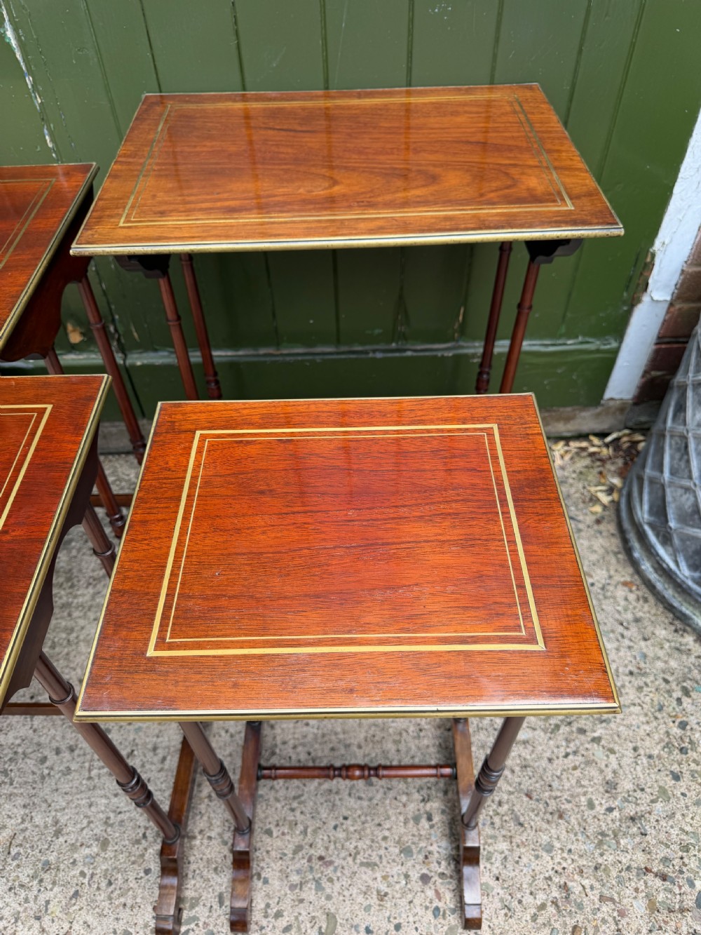 An early nineteenth-century Regency quartetto set of four rosewood nesting tables with brass line inlay and slender turned legs. View XI