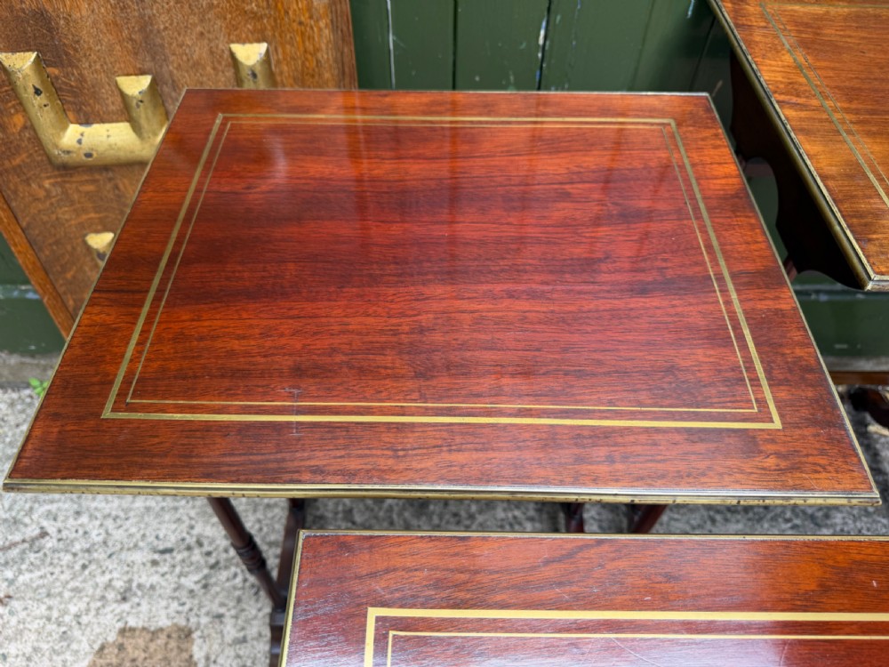An early nineteenth-century Regency quartetto set of four rosewood nesting tables with brass line inlay and slender turned legs. View XII