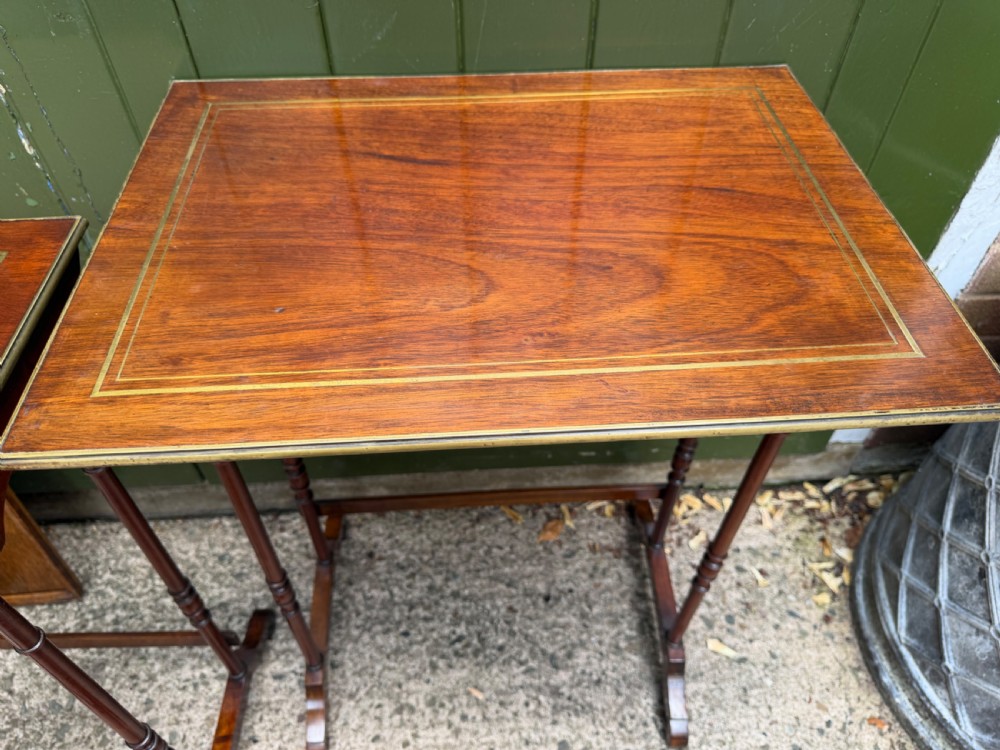 An early nineteenth-century Regency quartetto set of four rosewood nesting tables with brass line inlay and slender turned legs. View XIII