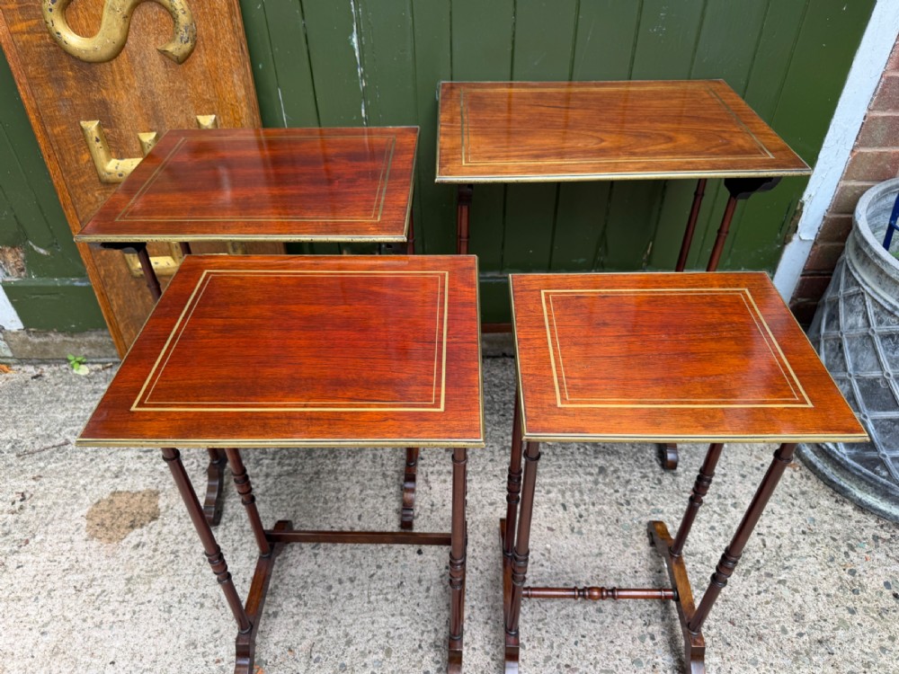 An early nineteenth-century Regency quartetto set of four rosewood nesting tables with brass line inlay and slender turned legs. View XVI