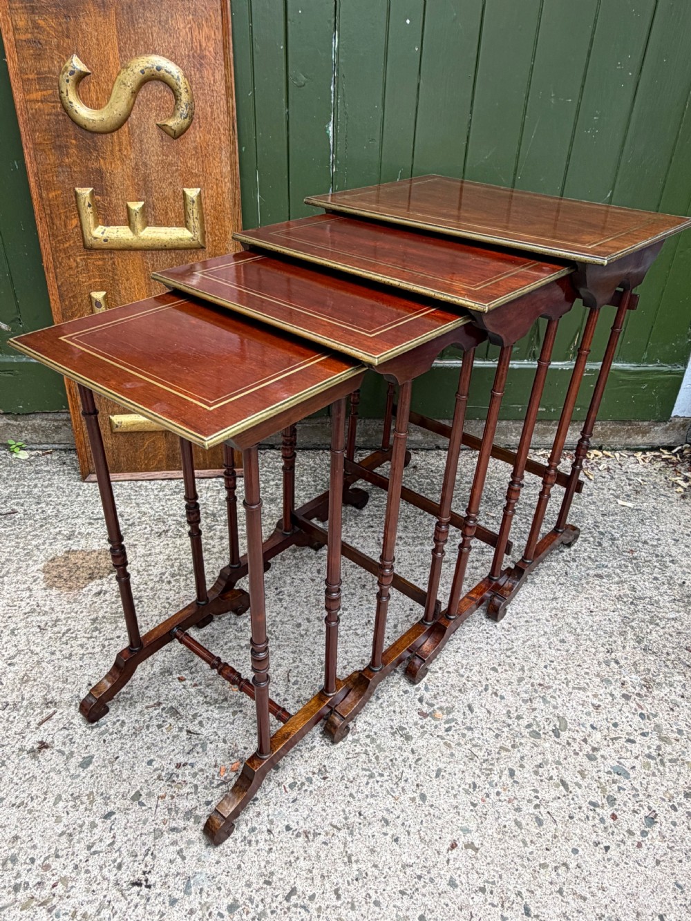 An early nineteenth-century Regency quartetto set of four rosewood nesting tables with brass line inlay and slender turned legs. View XVII