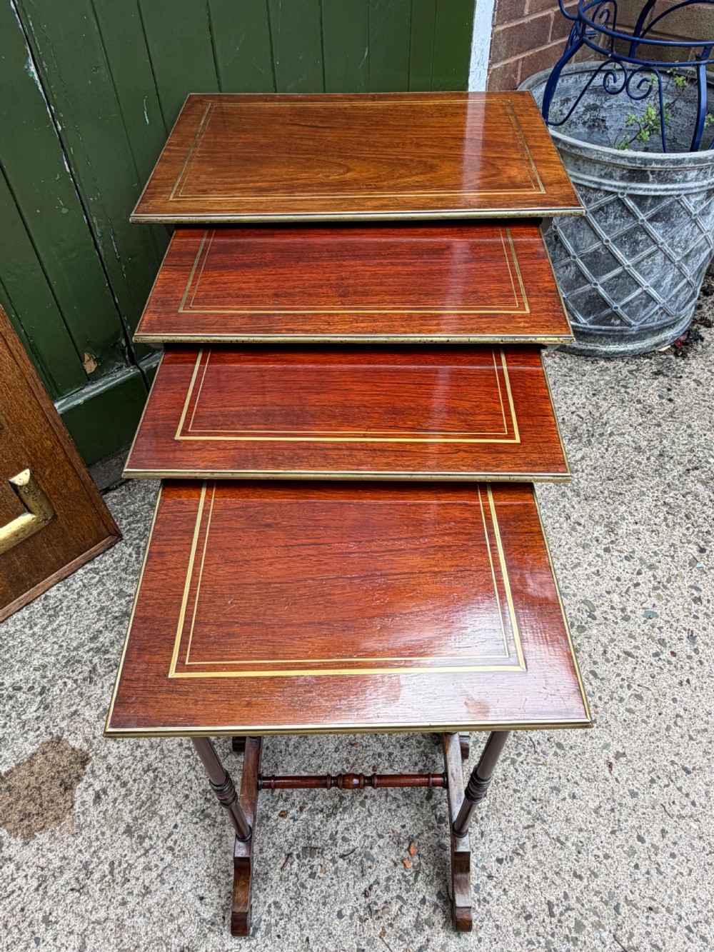 An early nineteenth-century Regency quartetto set of four rosewood nesting tables with brass line inlay and slender turned legs. View XIX