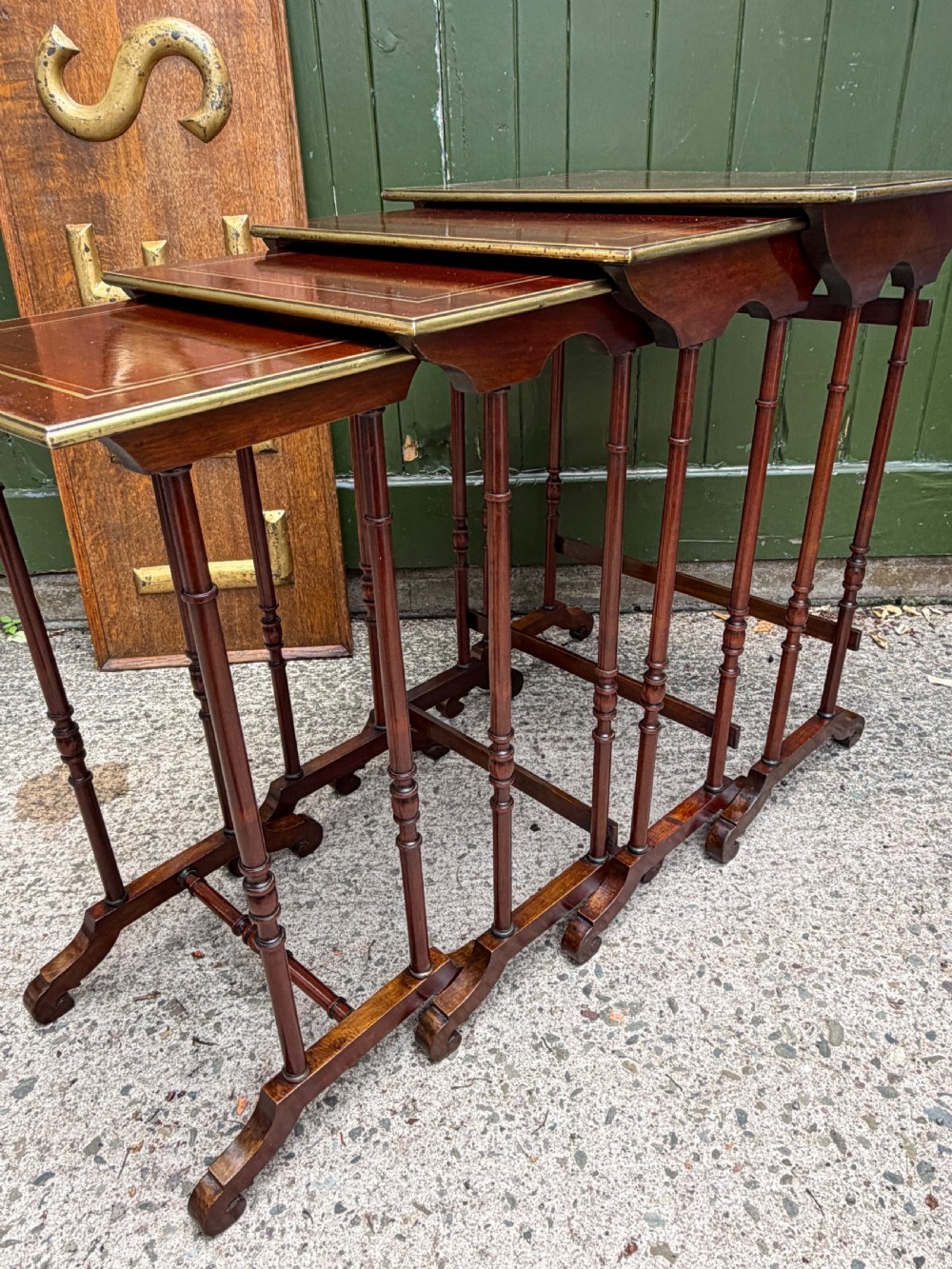 An early nineteenth-century Regency quartetto set of four rosewood nesting tables with brass line inlay and slender turned legs. View XX