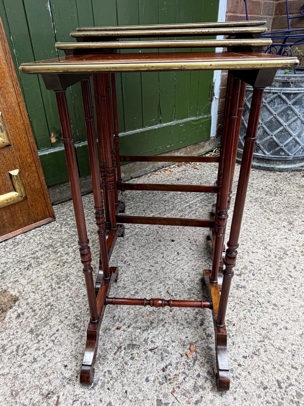 An early nineteenth-century Regency quartetto set of four rosewood nesting tables with brass line inlay and slender turned legs. View XXIII