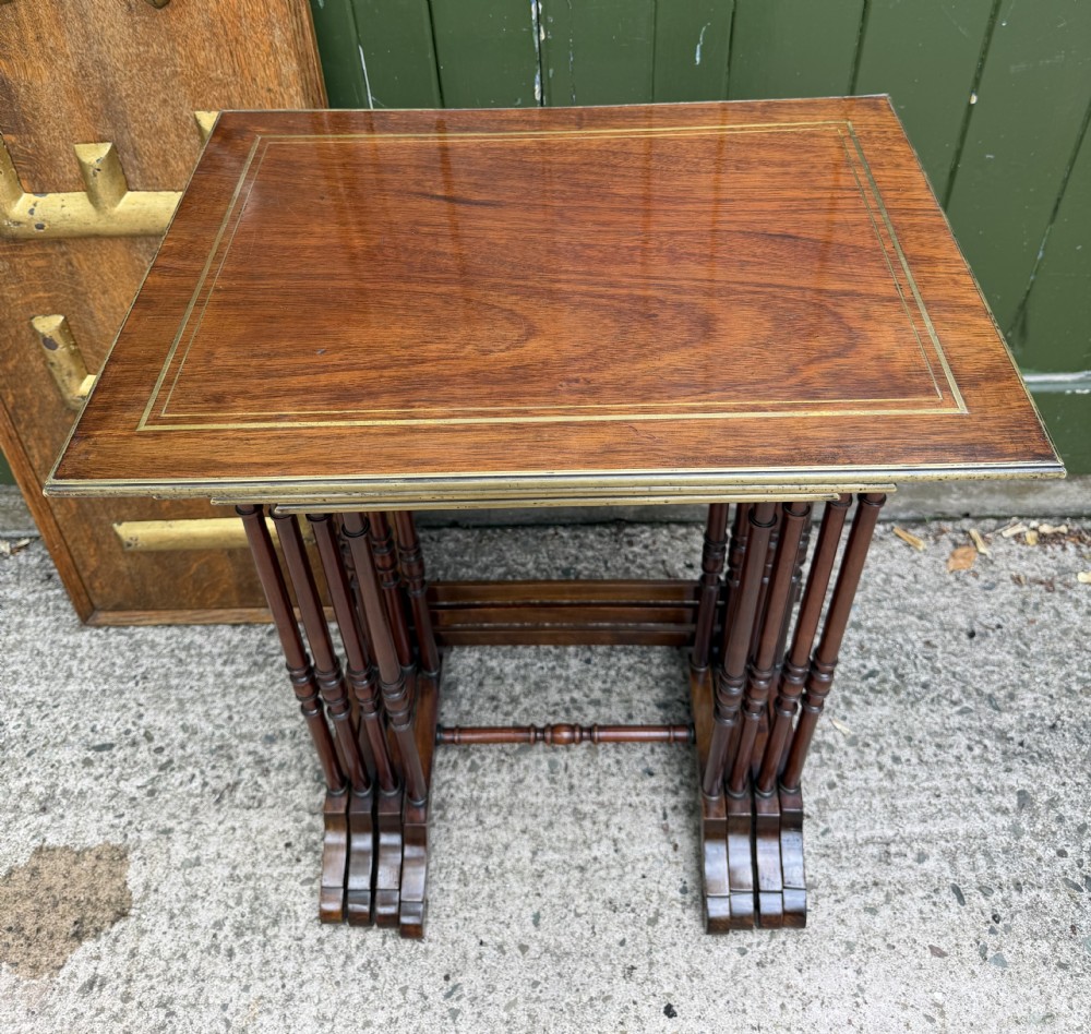An early nineteenth-century Regency quartetto set of four rosewood nesting tables with brass line inlay and slender turned legs. View II