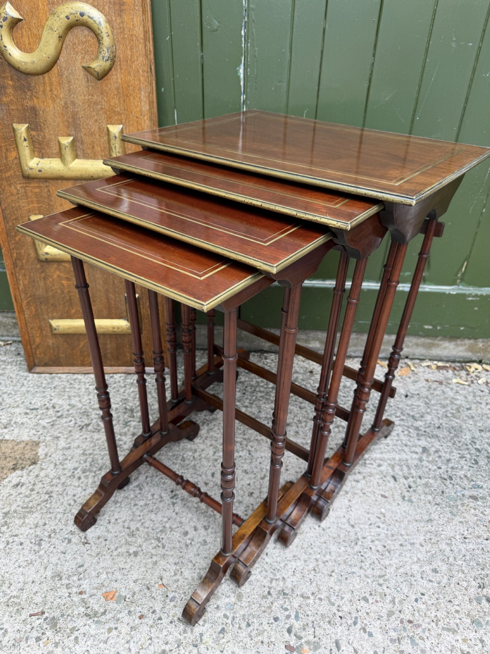 An early nineteenth-century Regency quartetto set of four rosewood nesting tables with brass line inlay and slender turned legs. View XXV