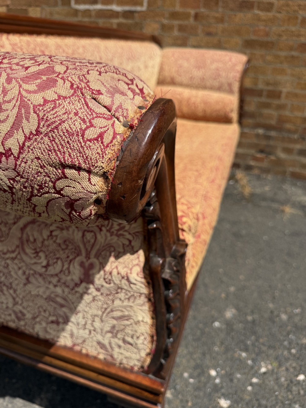 Early 19th-century William IV carved mahogany scroll-end sofa upholstered in red and gold patterned damask with matching bolster cushions. View XVIII
