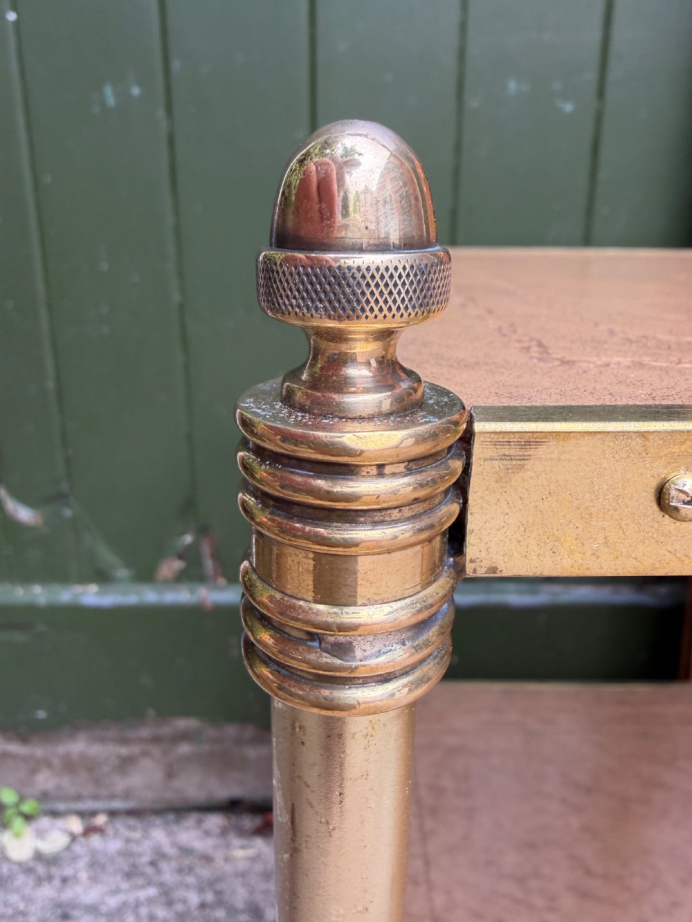 A pair of early twentieth-century two-tier lacquered brass etagere tables featuring inset tan tooled leather tops and turned brass corner posts. View V