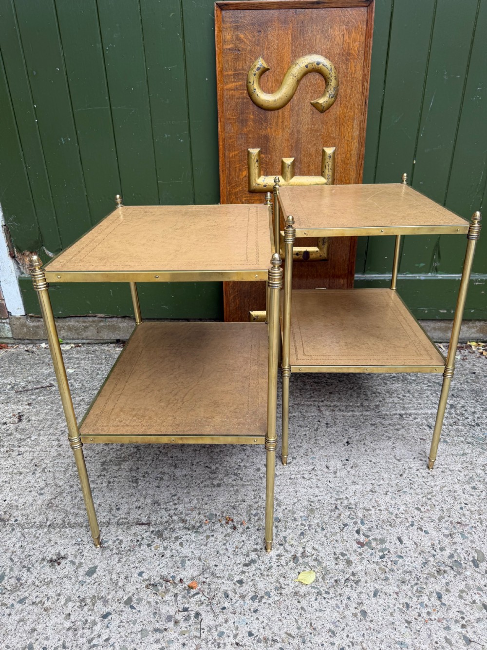 A pair of early twentieth-century two-tier lacquered brass etagere tables featuring inset tan tooled leather tops and turned brass corner posts. View VIII