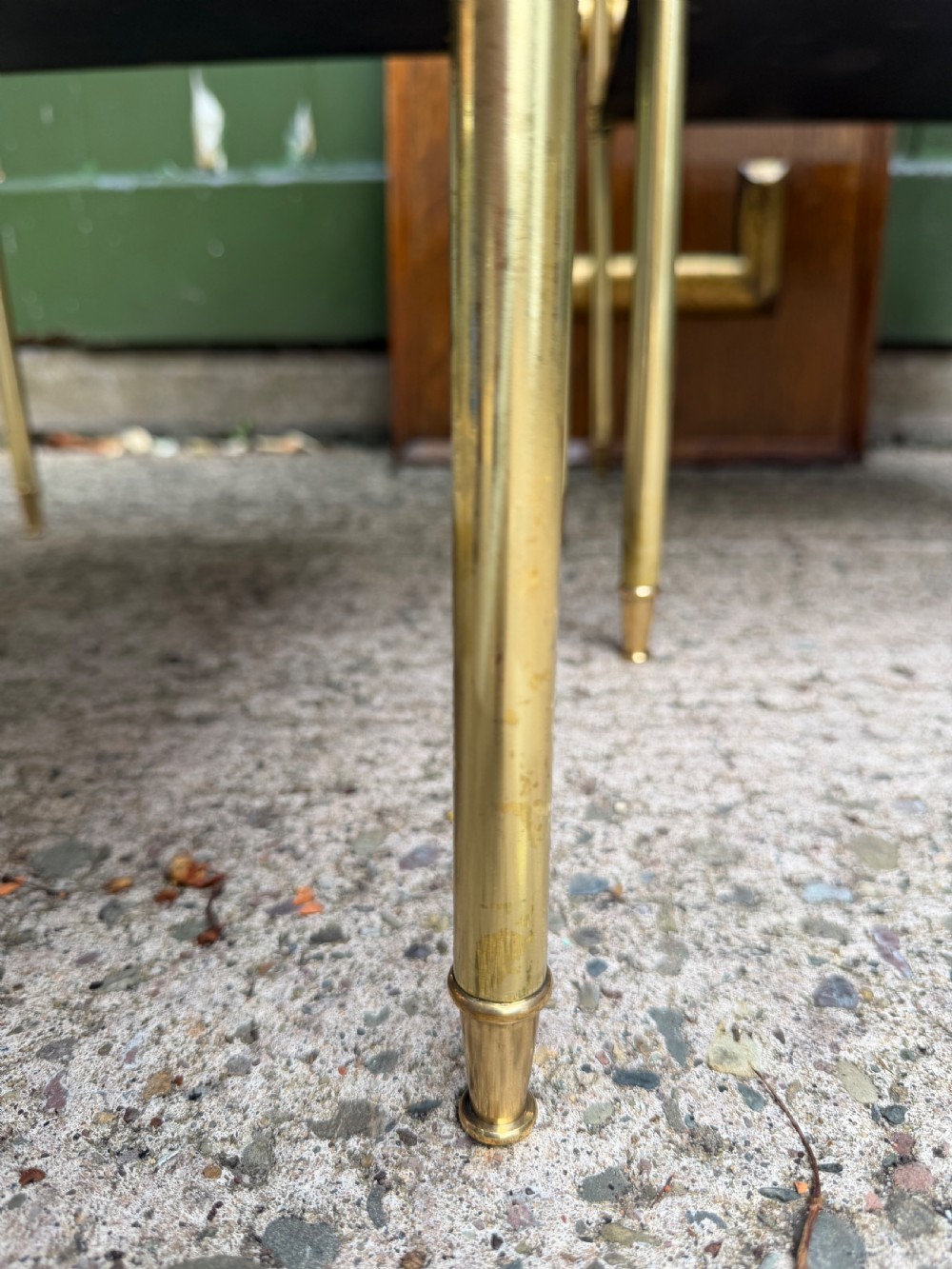 A pair of early twentieth-century two-tier lacquered brass etagere tables featuring inset tan tooled leather tops and turned brass corner posts. View XII