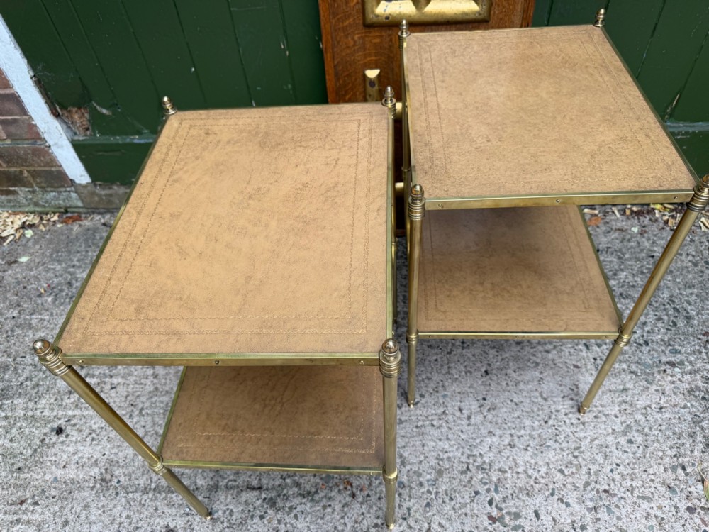 A pair of early twentieth-century two-tier lacquered brass etagere tables featuring inset tan tooled leather tops and turned brass corner posts. View XIII