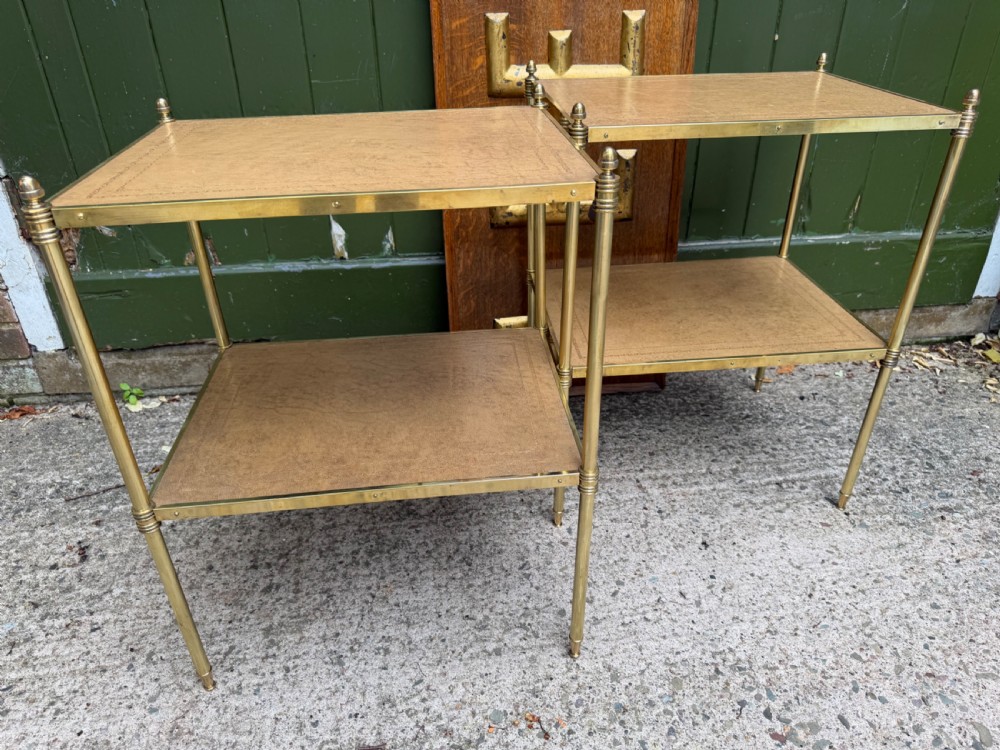 A pair of early twentieth-century two-tier lacquered brass etagere tables featuring inset tan tooled leather tops and turned brass corner posts. View XIV