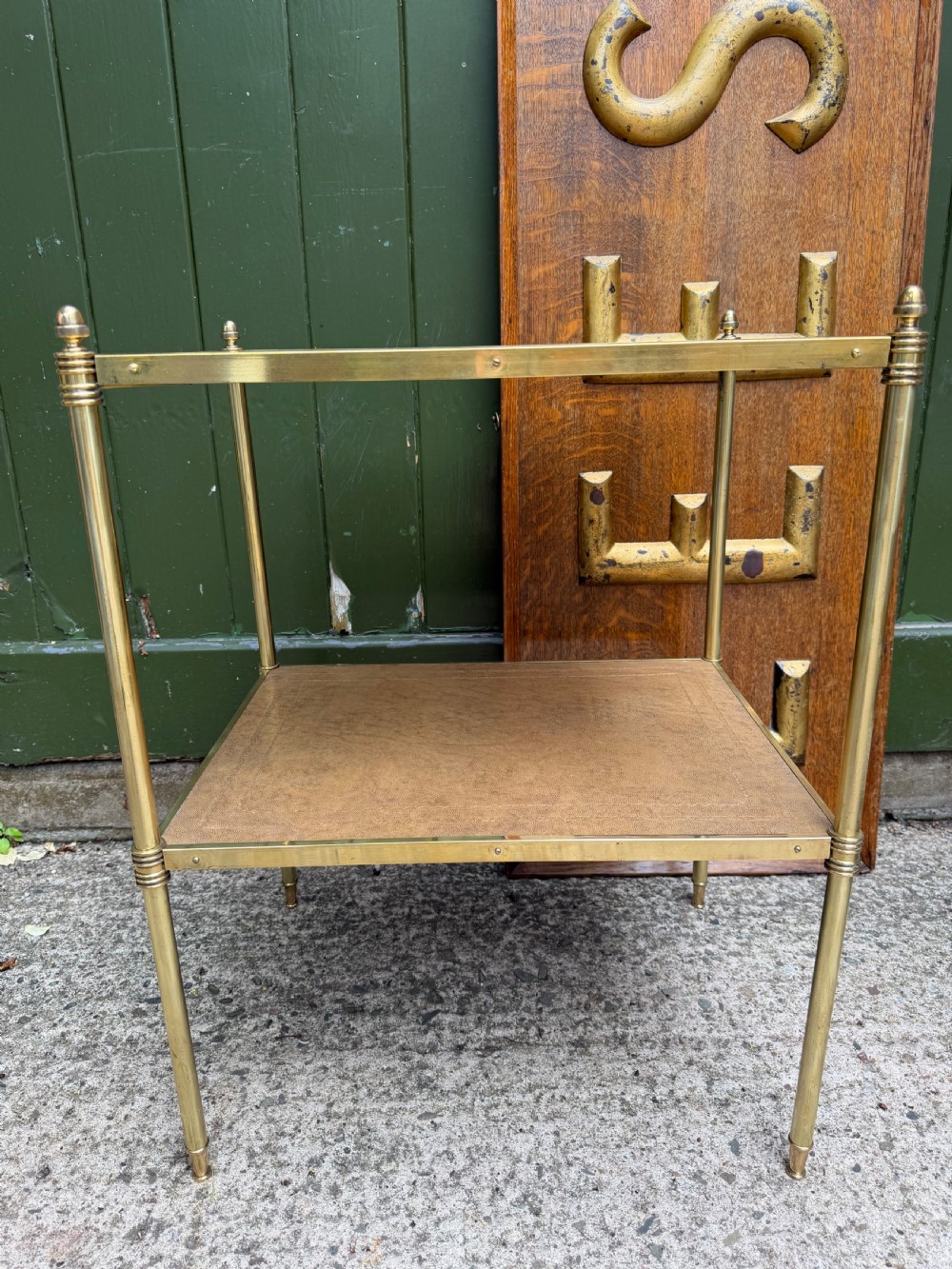 A pair of early twentieth-century two-tier lacquered brass etagere tables featuring inset tan tooled leather tops and turned brass corner posts. View XVIII