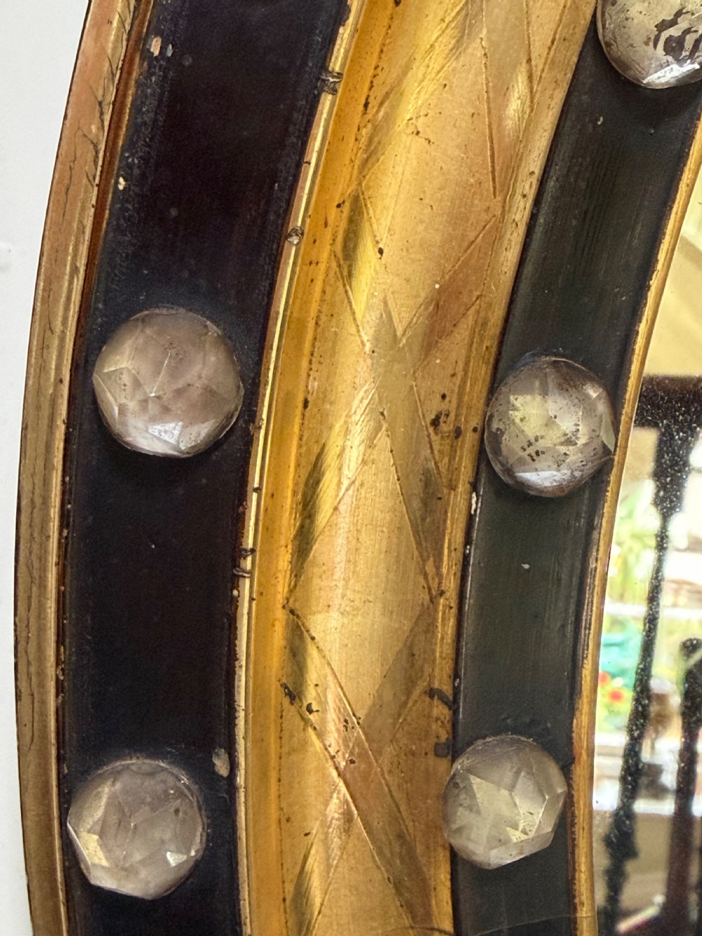 Scarce pair of early C19th Irish oval ebonised , parcel-gilt and glass cabochon mounted mirrors of smaller scale . View V