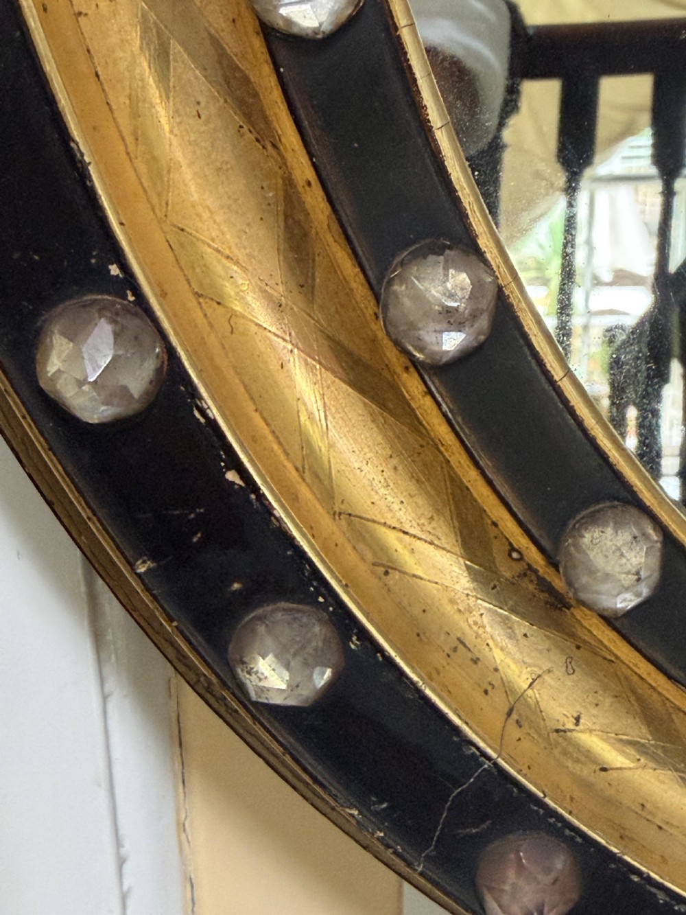 Scarce pair of early C19th Irish oval ebonised , parcel-gilt and glass cabochon mounted mirrors of smaller scale . View VIII
