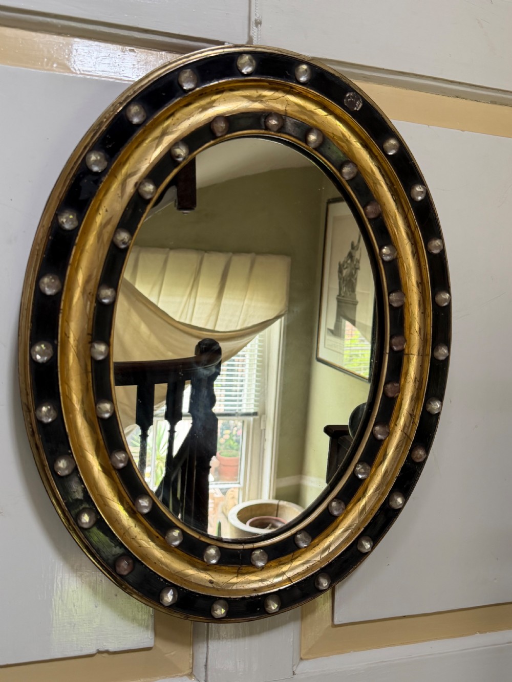 Scarce pair of early C19th Irish oval ebonised , parcel-gilt and glass cabochon mounted mirrors of smaller scale . View XII