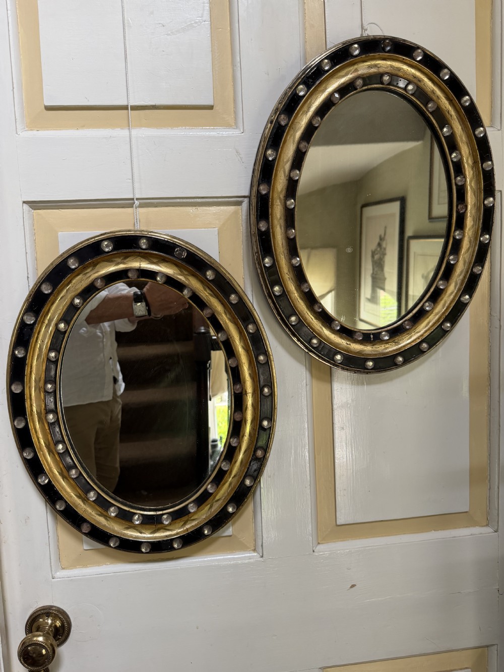 Scarce pair of early C19th Irish oval ebonised , parcel-gilt and glass cabochon mounted mirrors of smaller scale . View XVI