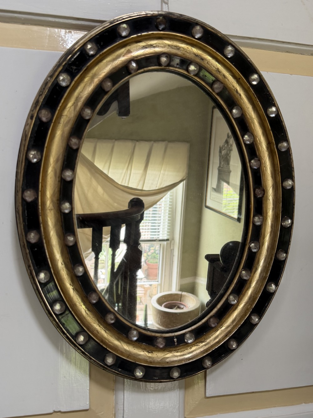 Scarce pair of early C19th Irish oval ebonised , parcel-gilt and glass cabochon mounted mirrors of smaller scale . View XVIII