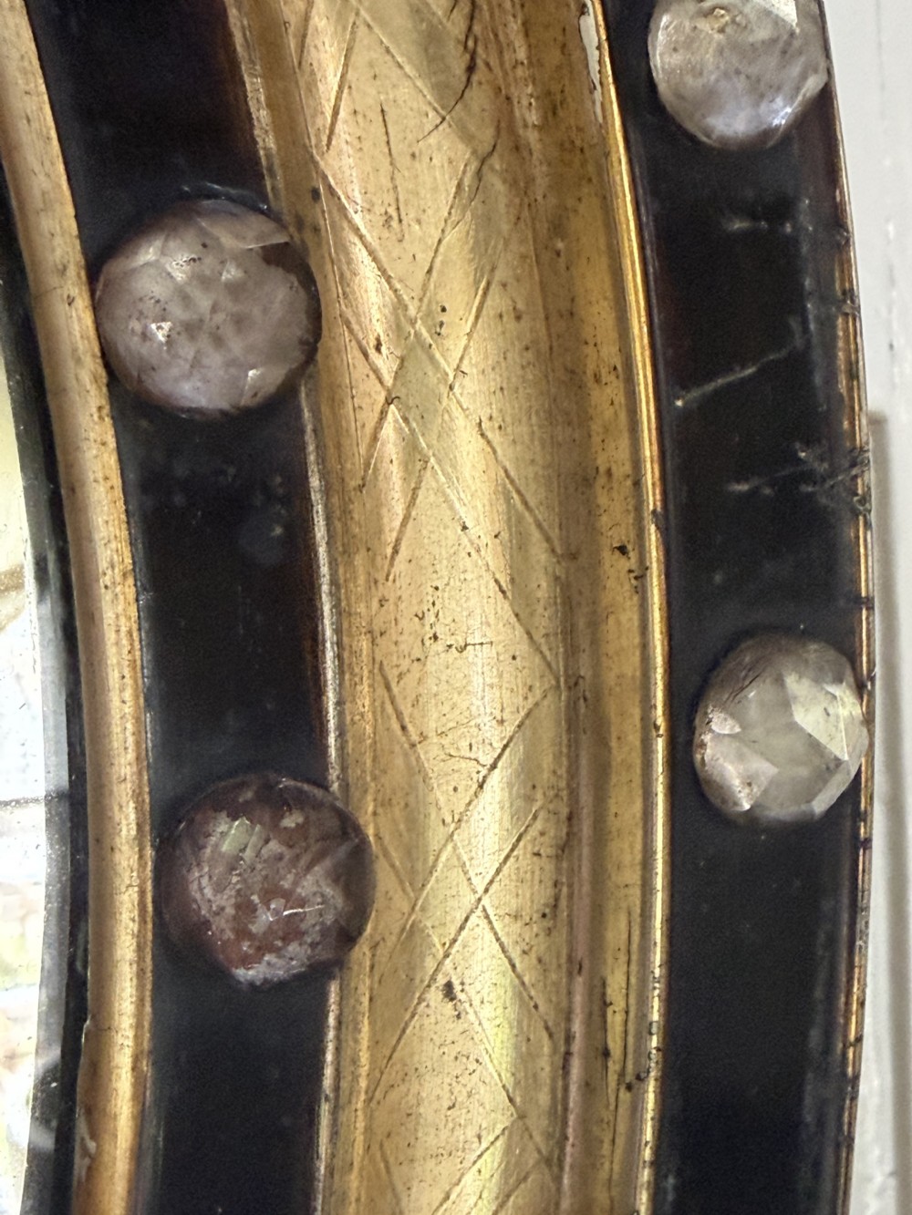 Scarce pair of early C19th Irish oval ebonised , parcel-gilt and glass cabochon mounted mirrors of smaller scale . View XVII