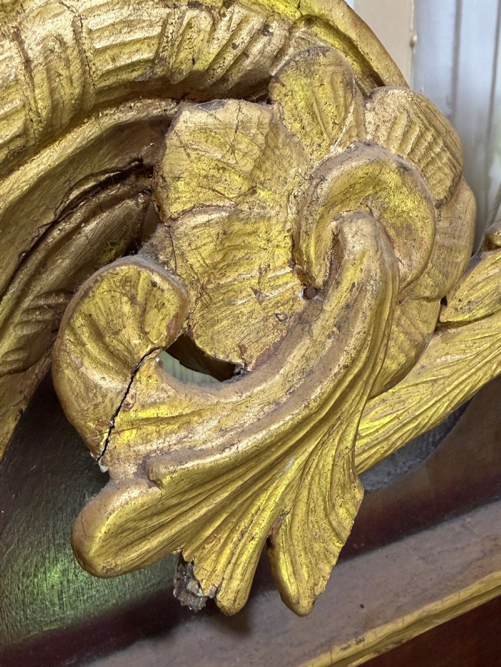 A nineteenth-century George II revival mahogany pier mirror featuring parcel-gilt mouldings, side foliage carvings, a broken pediment, and a carved eagle finial. View XI