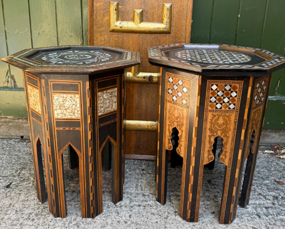 A matched pair of late 19th-century octagonal Moorish style occasional tables featuring detailed geometric mother-of-pearl and bone marquetry inlays with arched leg cutouts.