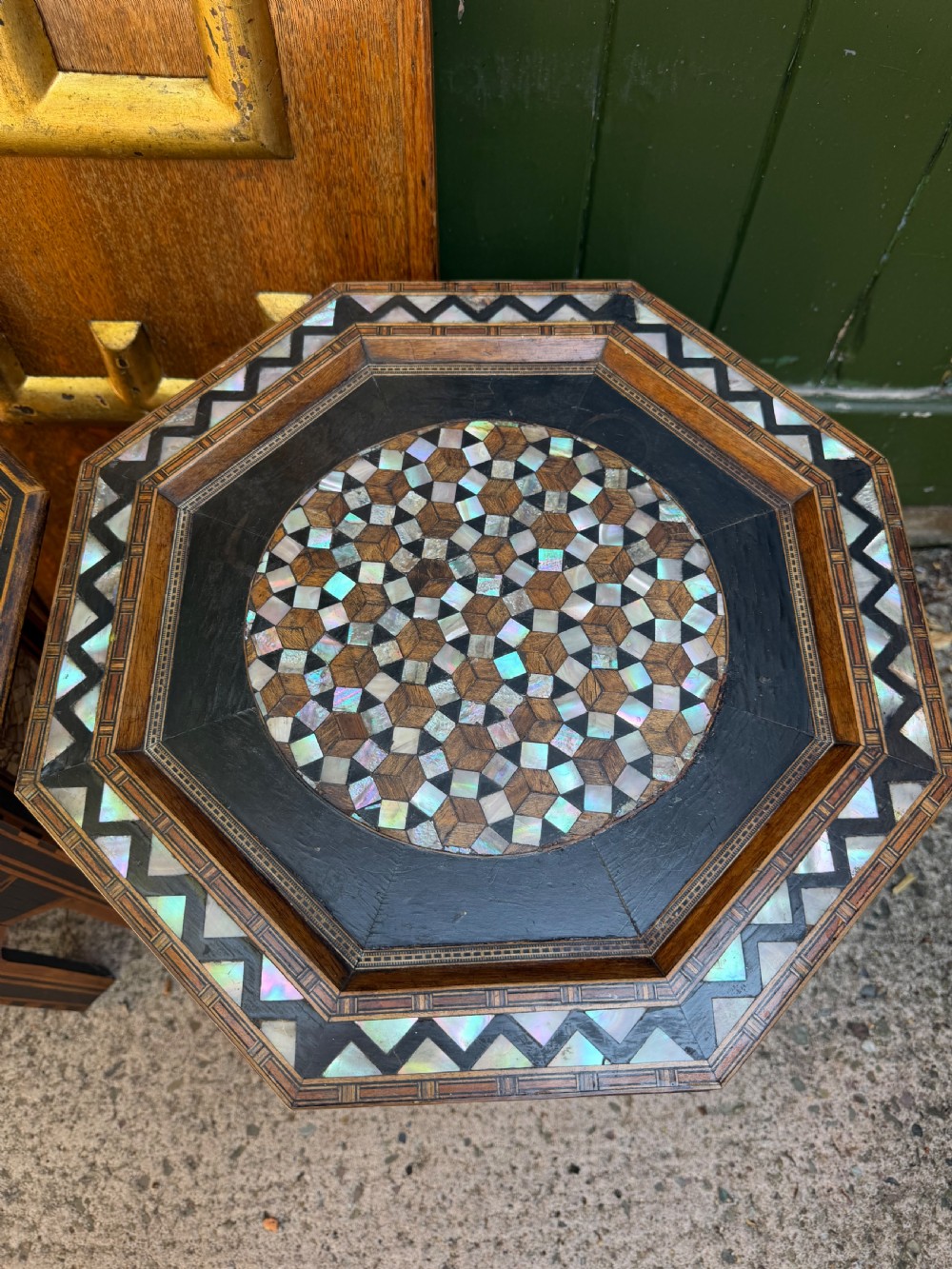 A matched pair of late 19th-century octagonal Moorish style occasional tables featuring detailed geometric mother-of-pearl and bone marquetry inlays with arched leg cutouts. View IV