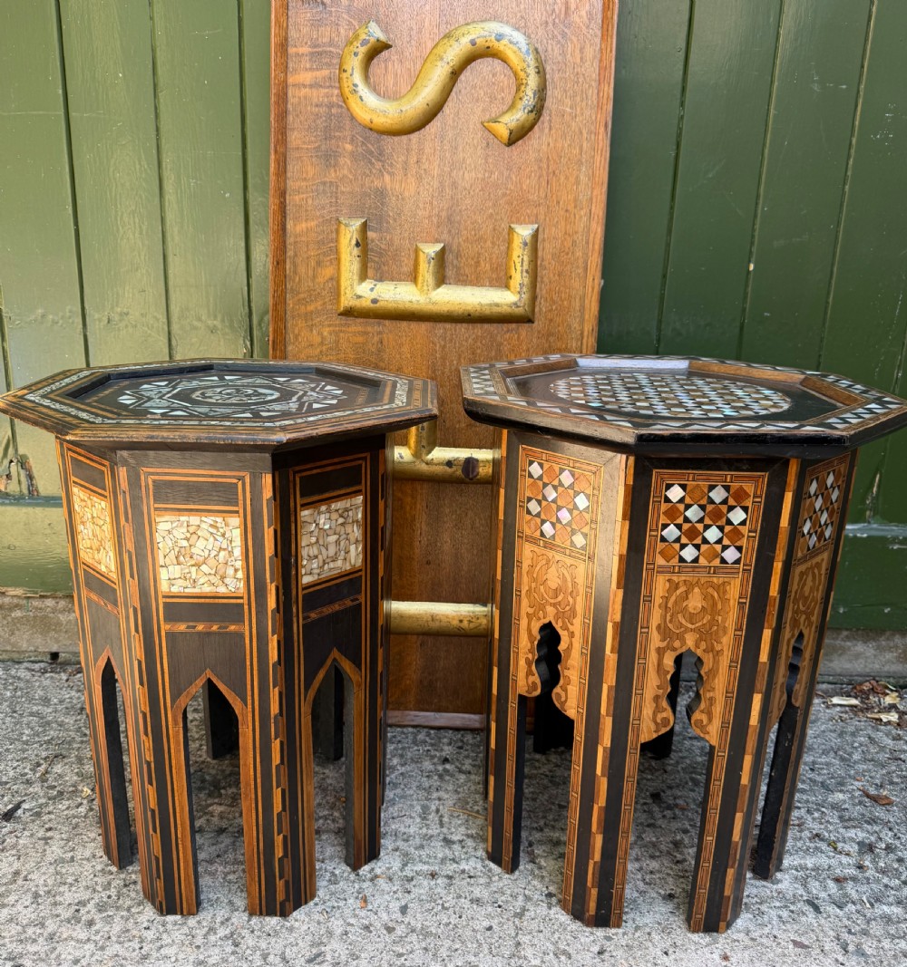 A matched pair of late 19th-century octagonal Moorish style occasional tables featuring detailed geometric mother-of-pearl and bone marquetry inlays with arched leg cutouts. View V