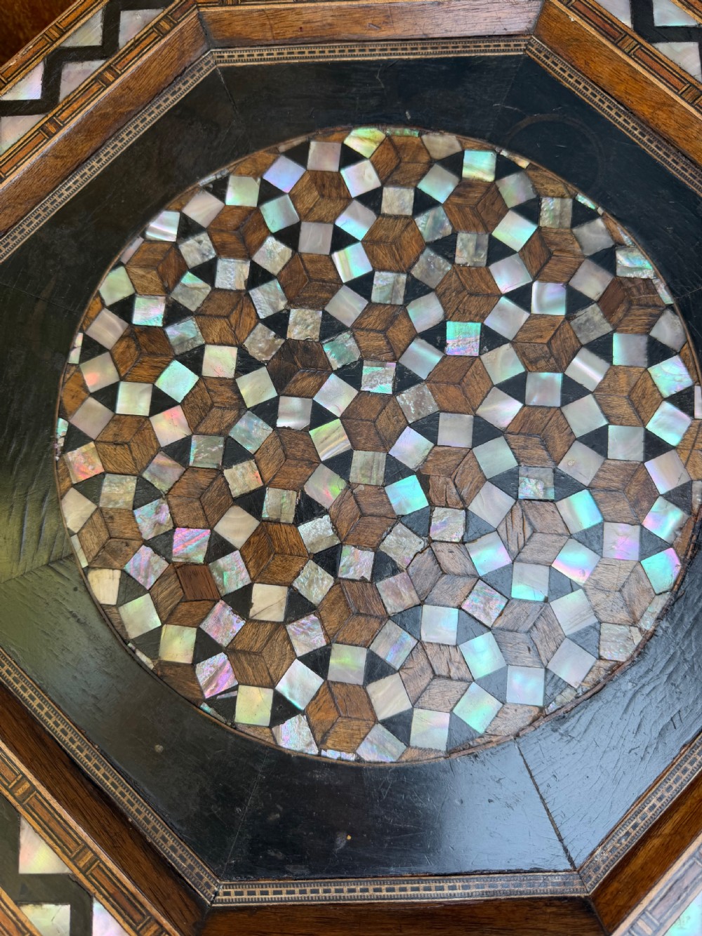 A matched pair of late 19th-century octagonal Moorish style occasional tables featuring detailed geometric mother-of-pearl and bone marquetry inlays with arched leg cutouts. View VI