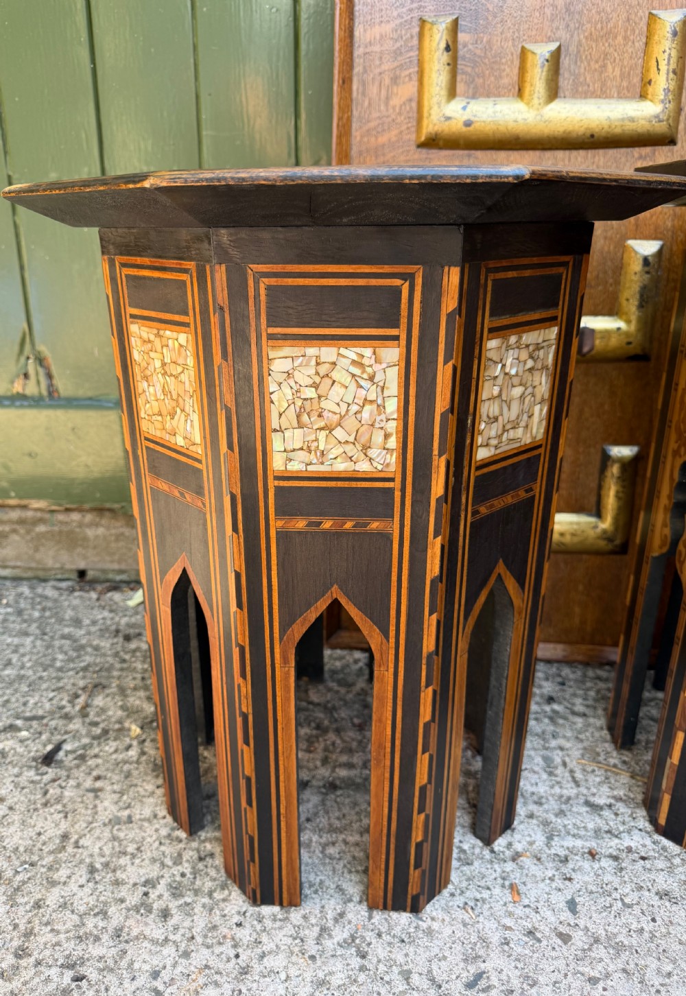 A matched pair of late 19th-century octagonal Moorish style occasional tables featuring detailed geometric mother-of-pearl and bone marquetry inlays with arched leg cutouts. View VII