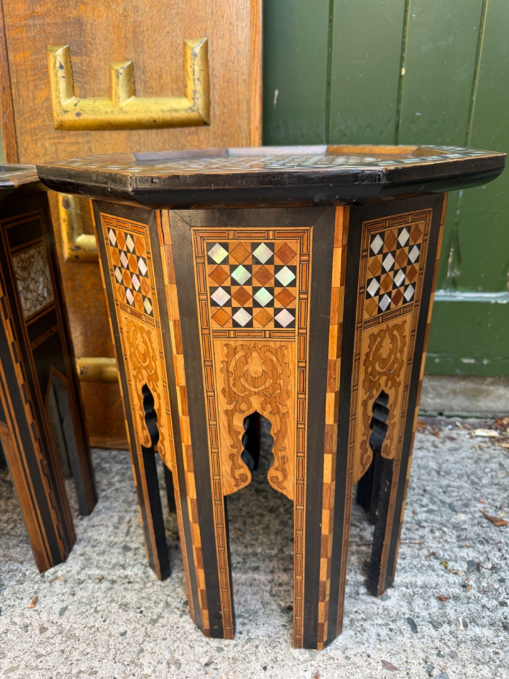 A matched pair of late 19th-century octagonal Moorish style occasional tables featuring detailed geometric mother-of-pearl and bone marquetry inlays with arched leg cutouts. View VIII