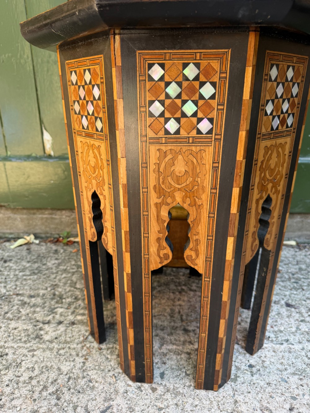 A matched pair of late 19th-century octagonal Moorish style occasional tables featuring detailed geometric mother-of-pearl and bone marquetry inlays with arched leg cutouts. View X