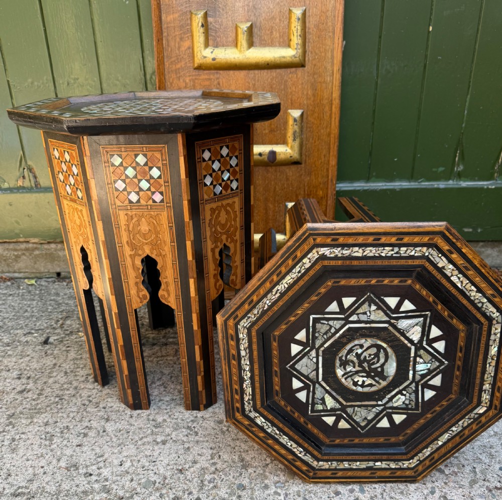 A matched pair of late 19th-century octagonal Moorish style occasional tables featuring detailed geometric mother-of-pearl and bone marquetry inlays with arched leg cutouts. View XVI