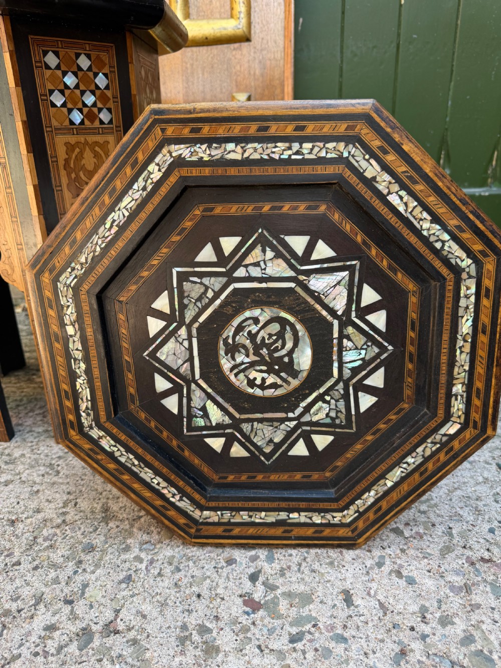 A matched pair of late 19th-century octagonal Moorish style occasional tables featuring detailed geometric mother-of-pearl and bone marquetry inlays with arched leg cutouts. View XVII