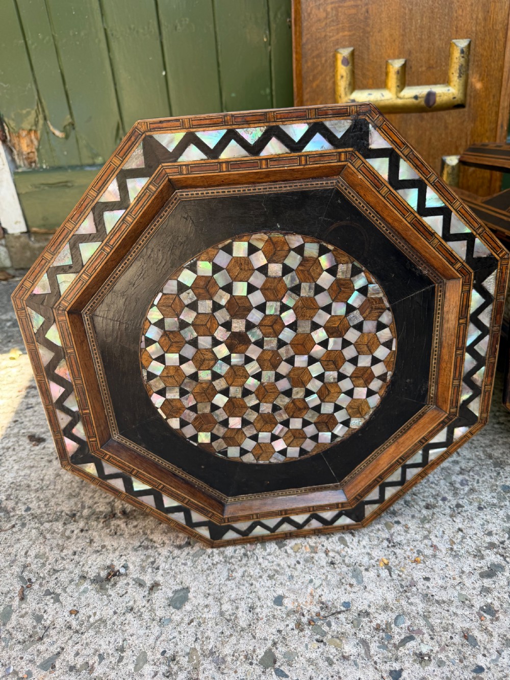 A matched pair of late 19th-century octagonal Moorish style occasional tables featuring detailed geometric mother-of-pearl and bone marquetry inlays with arched leg cutouts. View XVIII