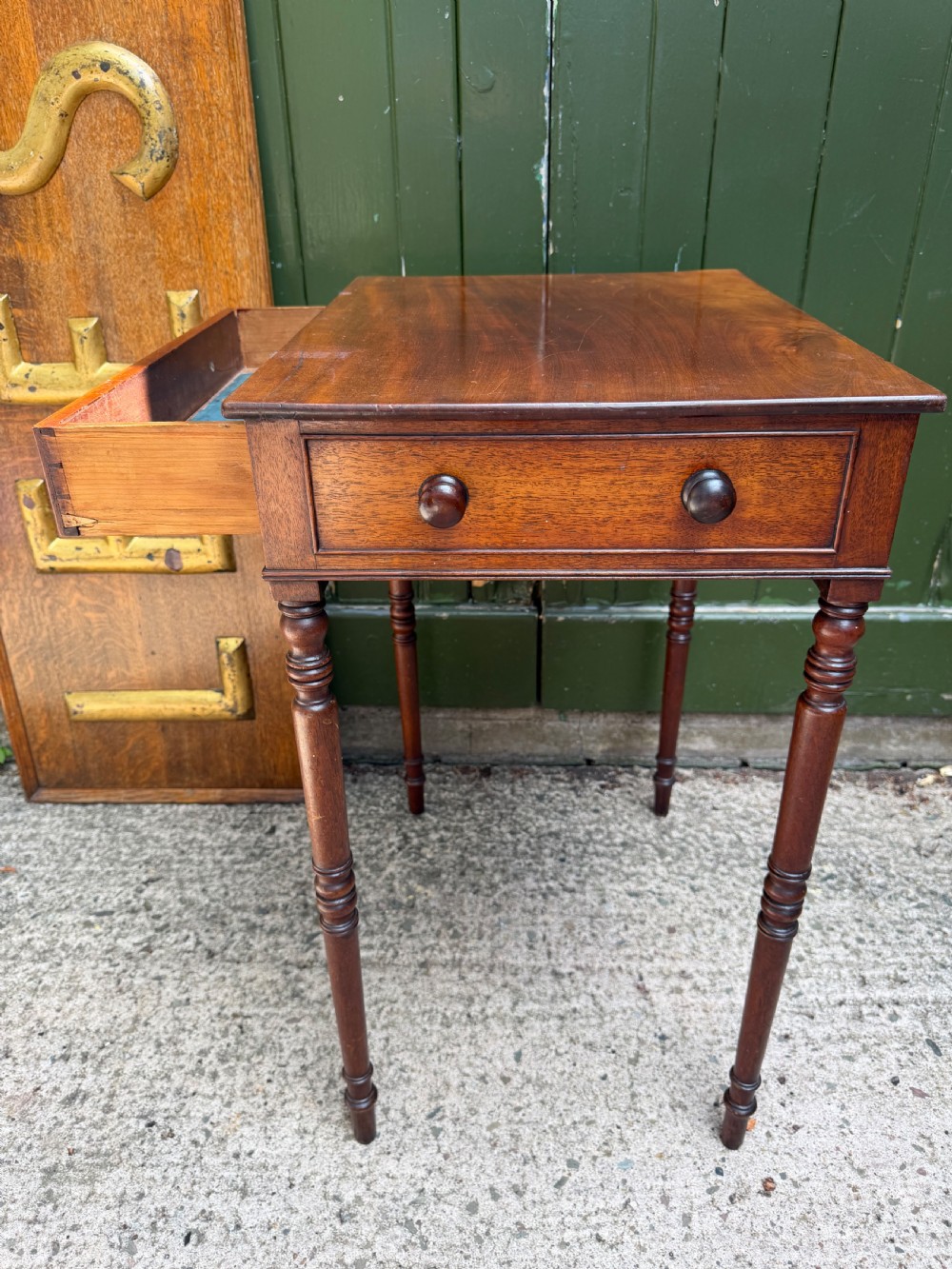 An early 19th-century George III period rectangular mahogany side table featuring a single drawer with turned wood handles and slender ring-turned legs. View II