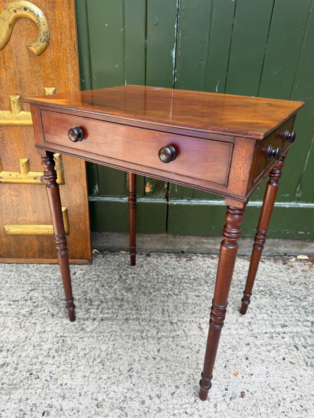 An early 19th-century George III period rectangular mahogany side table featuring a single drawer with turned wood handles and slender ring-turned legs. View III
