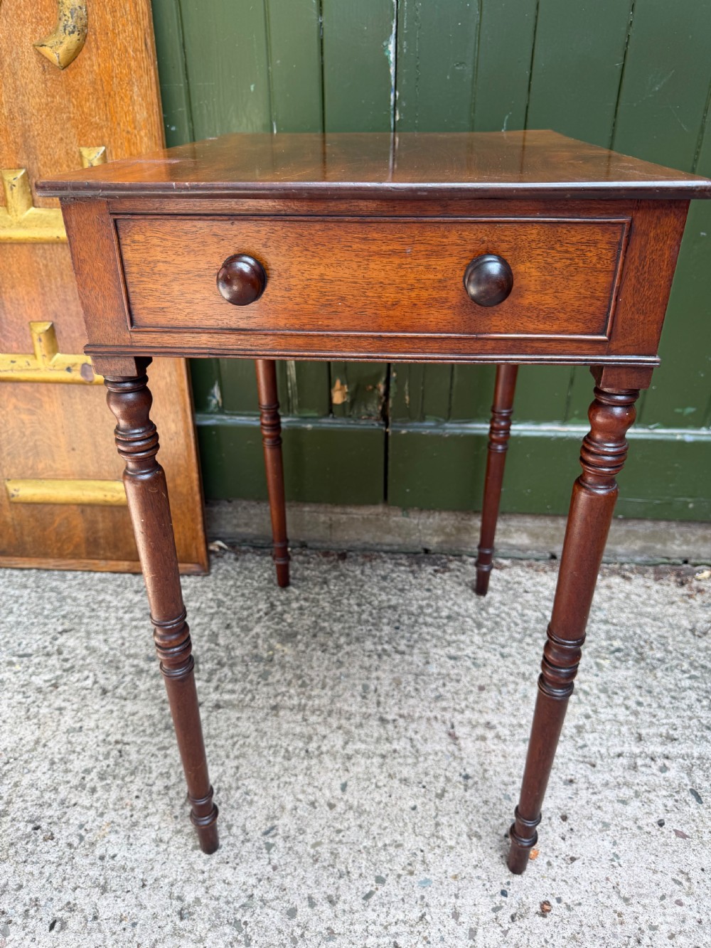 An early 19th-century George III period rectangular mahogany side table featuring a single drawer with turned wood handles and slender ring-turned legs. View IV