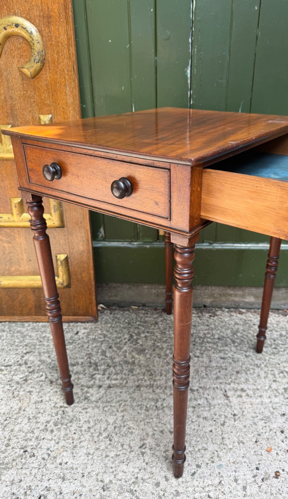 An early 19th-century George III period rectangular mahogany side table featuring a single drawer with turned wood handles and slender ring-turned legs. View V