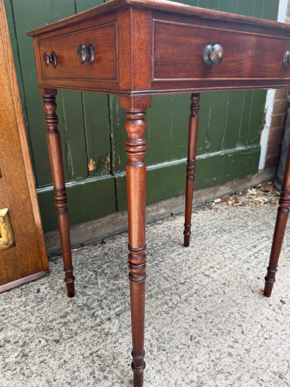 An early 19th-century George III period rectangular mahogany side table featuring a single drawer with turned wood handles and slender ring-turned legs. View VII