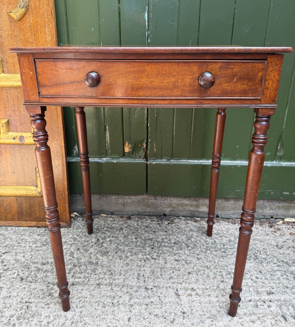 An early 19th-century George III period rectangular mahogany side table featuring a single drawer with turned wood handles and slender ring-turned legs. View IX