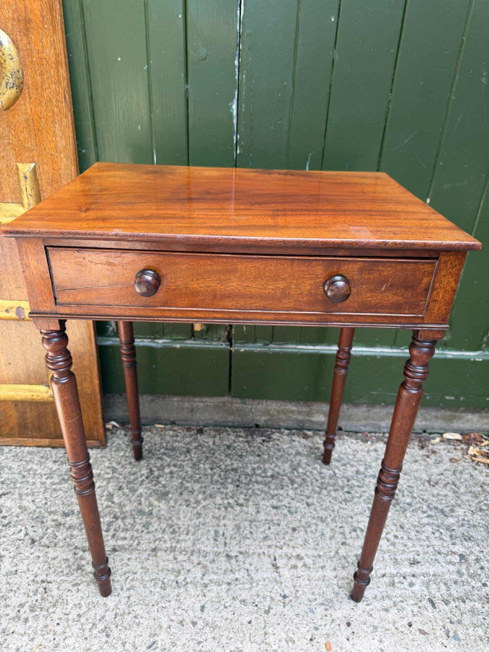 An early 19th-century George III period rectangular mahogany side table featuring a single drawer with turned wood handles and slender ring-turned legs. View X