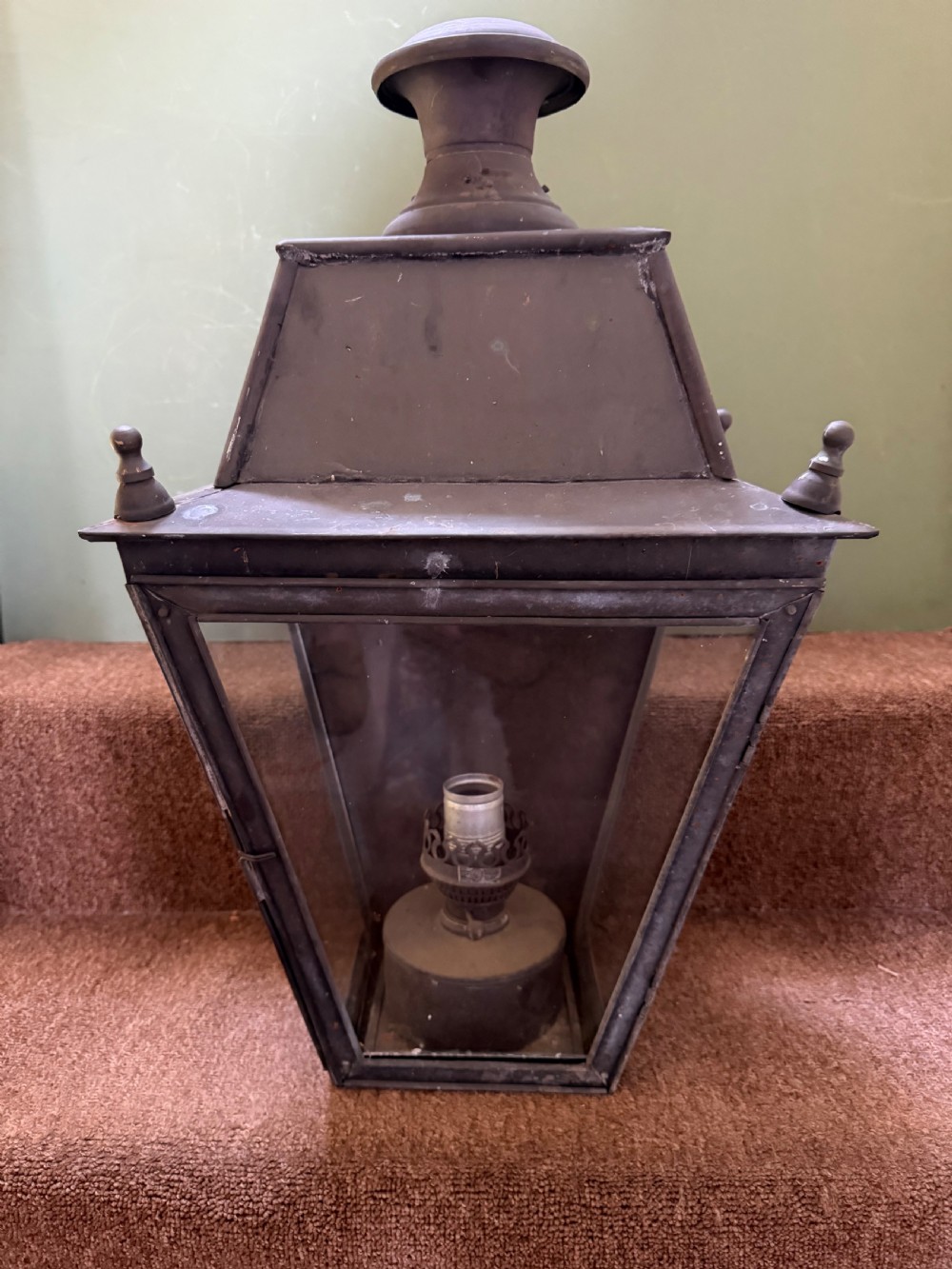 A pair of late nineteenth to early twentieth-century tapered copper wall lanterns with glass panels, top chimneys, and a dark verdigris finish. View IV