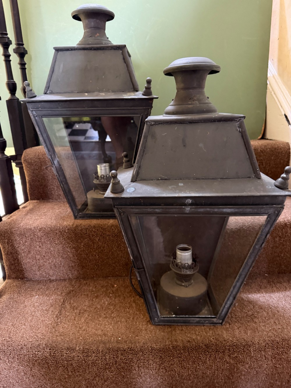 A pair of late nineteenth to early twentieth-century tapered copper wall lanterns with glass panels, top chimneys, and a dark verdigris finish. View V
