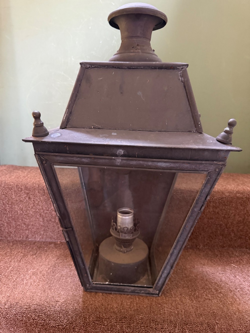 A pair of late nineteenth to early twentieth-century tapered copper wall lanterns with glass panels, top chimneys, and a dark verdigris finish. View VI