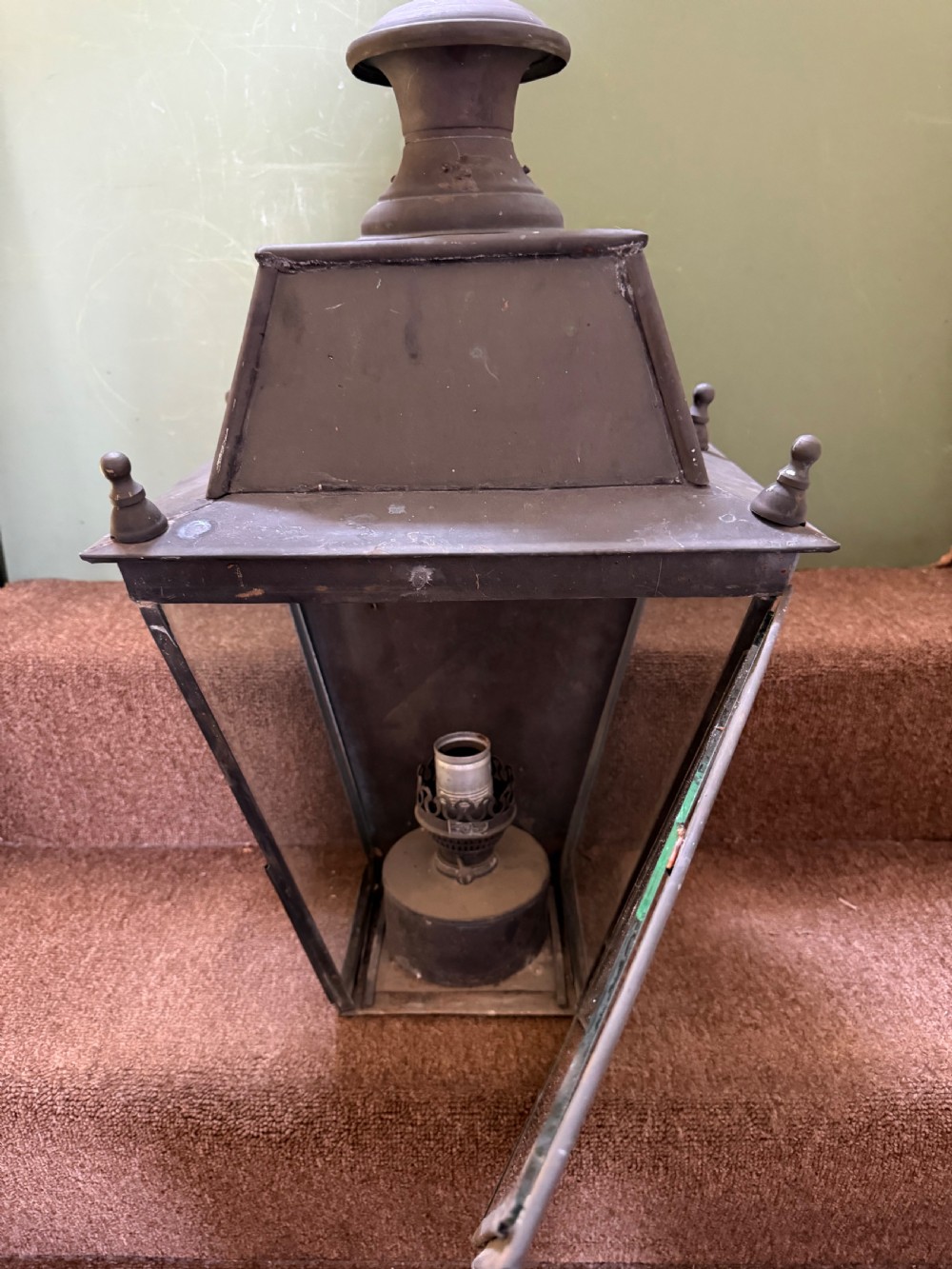 A pair of late nineteenth to early twentieth-century tapered copper wall lanterns with glass panels, top chimneys, and a dark verdigris finish. View VII
