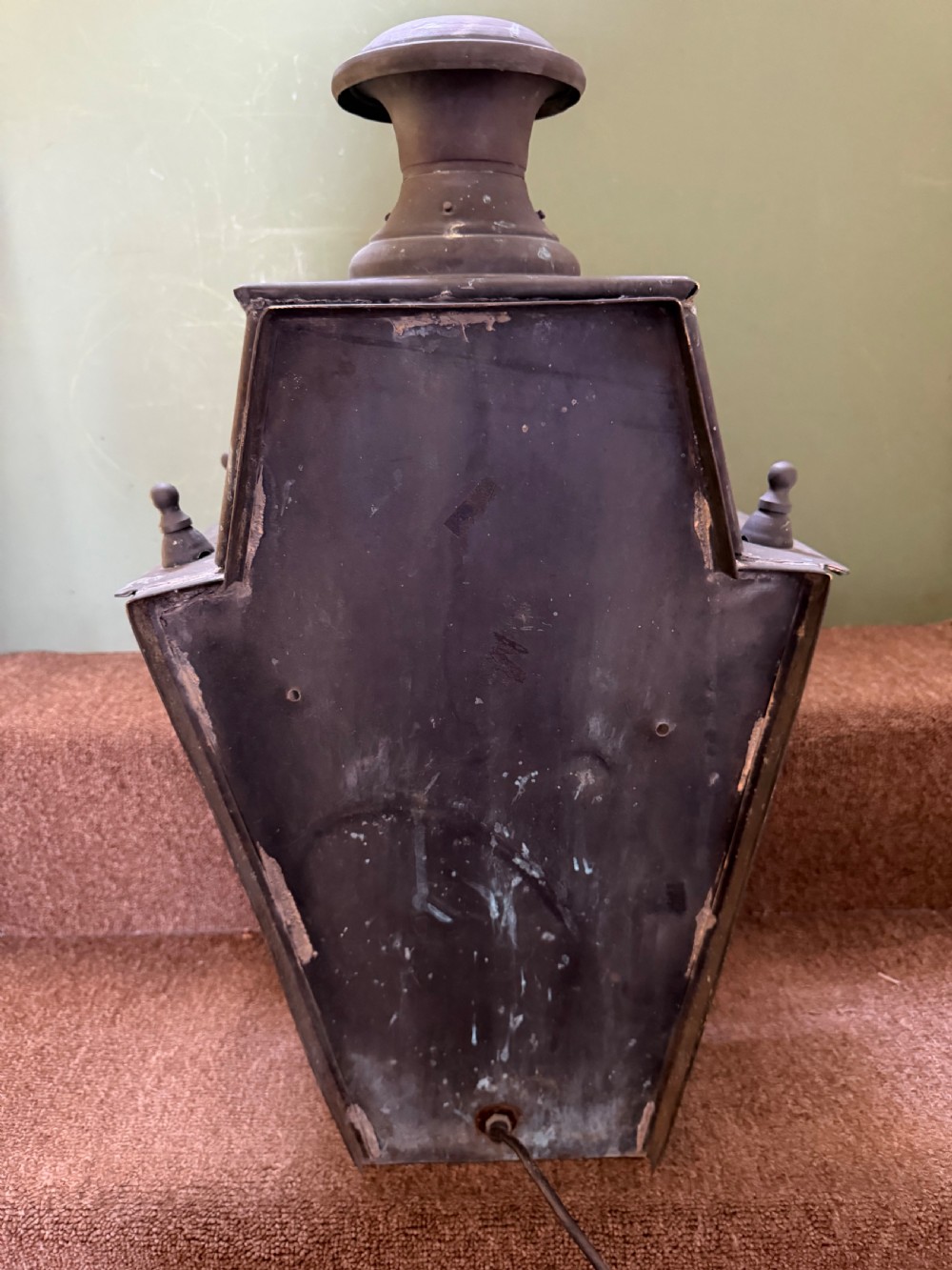 A pair of late nineteenth to early twentieth-century tapered copper wall lanterns with glass panels, top chimneys, and a dark verdigris finish. View XII
