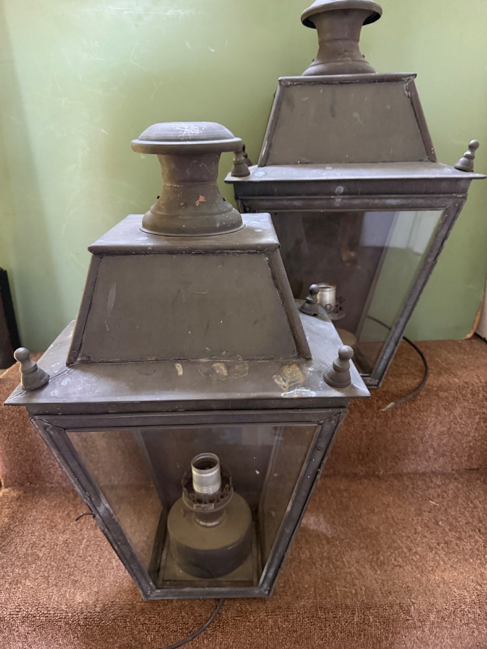 A pair of late nineteenth to early twentieth-century tapered copper wall lanterns with glass panels, top chimneys, and a dark verdigris finish. View XIII