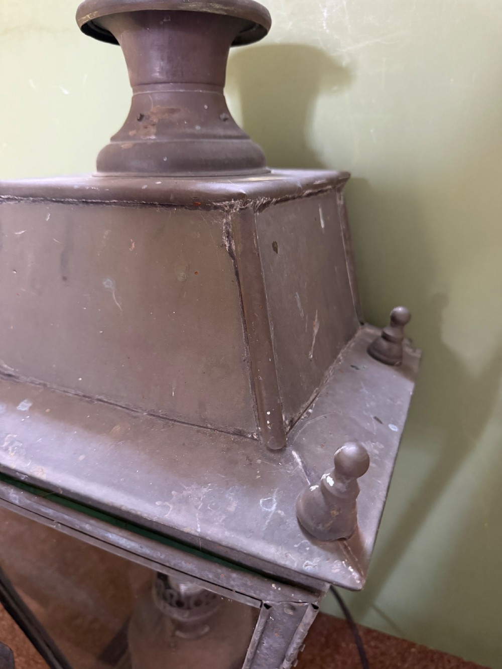 A pair of late nineteenth to early twentieth-century tapered copper wall lanterns with glass panels, top chimneys, and a dark verdigris finish. View XVI