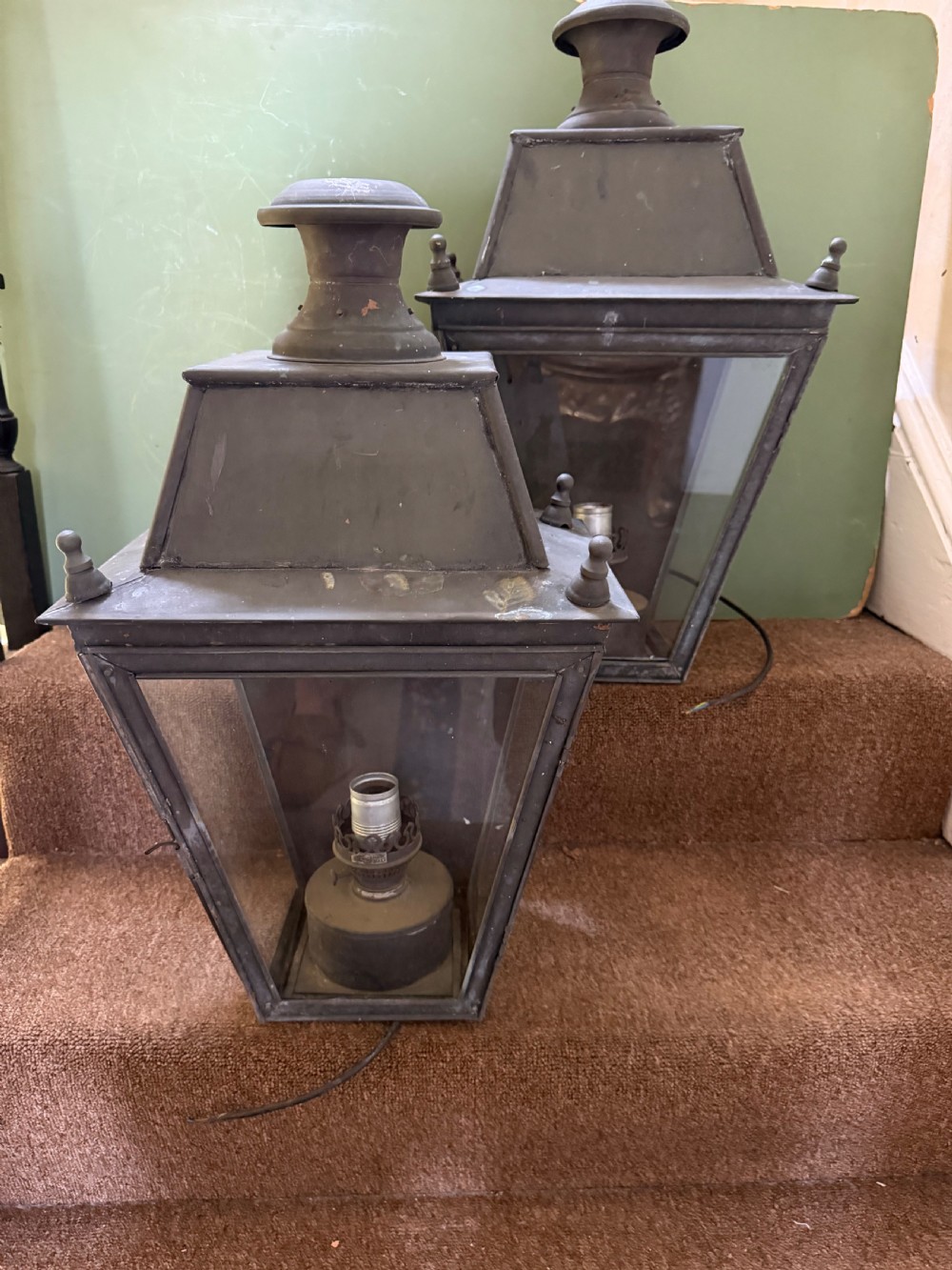 A pair of late nineteenth to early twentieth-century tapered copper wall lanterns with glass panels, top chimneys, and a dark verdigris finish. View XVIII